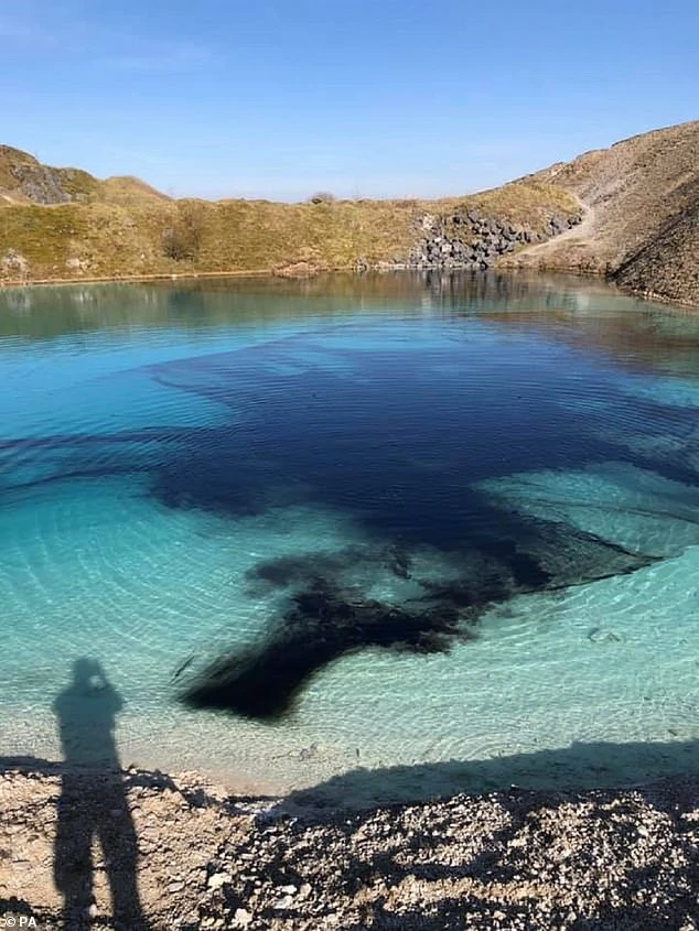 Police put black dye in the 'blue lagoon' at Harpur Hill, Buxton, to deter gatherings