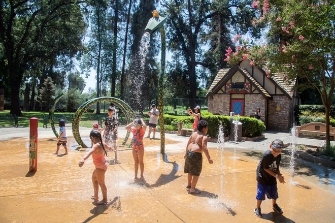 Children play in the dragon fountain at Pixie Woods in Stockton. The children's amusement park reopened on June 19, 2021 after being closed for more than a year due to the pandemic.