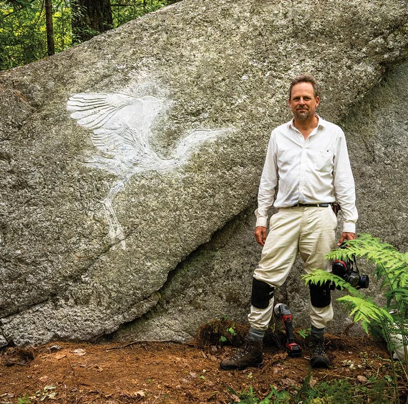 Kevin Sudeith and one of his stone carvings