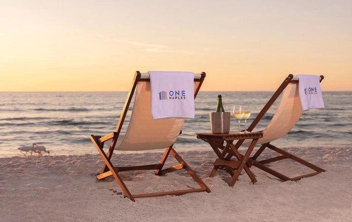 Above: Beach chairs by the shore One Naples residents can walk to Gulf Beach which is a minute or two walk from their front door.